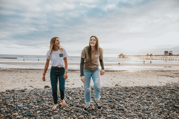 Meisjes lachen op het strand